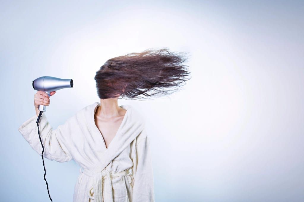 Long brown hair lifting in the air from a hair dryer