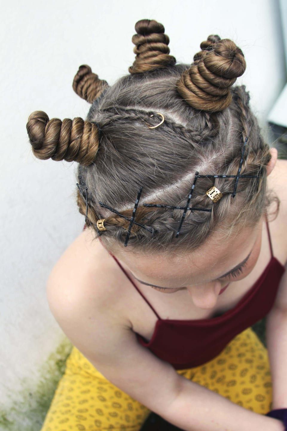 Two twisted buns with crossed braids, seen from above